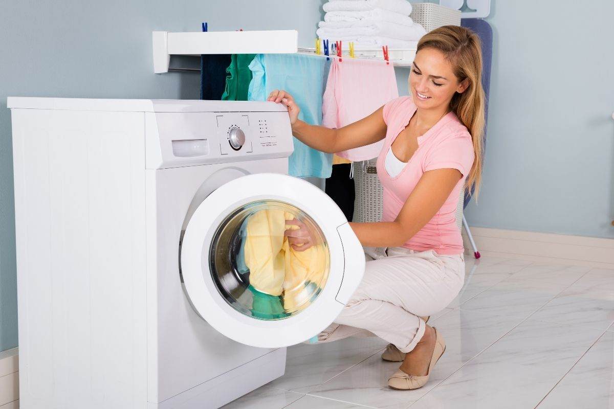 Donna mette panni in lavatrice